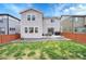 Spacious backyard with green lawn, patio, and a privacy fence in a residential neighborhood at 545 W 174Th Pl, Broomfield, CO 80023