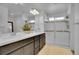 Bright bathroom featuring double sinks, white countertops, and a glass-enclosed shower at 545 W 174Th Pl, Broomfield, CO 80023