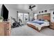 Bedroom with wooden bed frame, stationary bike, and dual windows, all illuminated by a ceiling fan at 545 W 174Th Pl, Broomfield, CO 80023