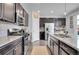 Well-equipped kitchen featuring stainless steel appliances, granite countertops, dark cabinets, and ample counter space at 545 W 174Th Pl, Broomfield, CO 80023