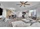 Inviting living space featuring a sectional sofa, dining area, open staircase, and view to modern kitchen at 545 W 174Th Pl, Broomfield, CO 80023