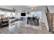 Open-concept living room featuring a modern sofa, dining area, and wood flooring for seamless entertaining at 545 W 174Th Pl, Broomfield, CO 80023