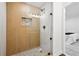 Modern bathroom featuring glass shower with wood-style tile and mosaic floor at 290 Beryl Way, Broomfield, CO 80020