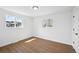 Clean bedroom with hardwood floors, white walls, and windows providing natural light at 290 Beryl Way, Broomfield, CO 80020
