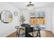 Bright dining room with modern lighting and a round table next to sliding glass doors at 290 Beryl Way, Broomfield, CO 80020