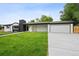 Beautiful single-story home with an attached garage, welcoming front porch, and manicured green lawn at 290 Beryl Way, Broomfield, CO 80020