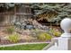 Landscaped backyard featuring a rock waterfall feature and manicured landscaping at 2250 Indian Paintbrush Cir, Highlands Ranch, CO 80129