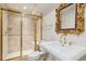 Bathroom with a glass door shower, a gold framed mirror and sink with gold hardware at 2250 Indian Paintbrush Cir, Highlands Ranch, CO 80129