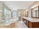 Elegant bathroom with dual vanities, a luxurious soaking tub, and a glass-enclosed shower at 2250 Indian Paintbrush Cir, Highlands Ranch, CO 80129