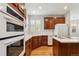 Traditional kitchen with wood cabinets, white appliances, and hardwood floors at 2250 Indian Paintbrush Cir, Highlands Ranch, CO 80129