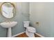 Stylish half bathroom featuring pedestal sink and decorative mirror at 2250 Indian Paintbrush Cir, Highlands Ranch, CO 80129