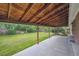 Covered patio offering shade, overlooking a large yard with mature trees at 3384 W Arlington Ave, Littleton, CO 80123