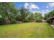 Spacious backyard with lush green grass, mature trees, and landscaping at 3384 W Arlington Ave, Littleton, CO 80123