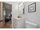 Clean and modern bathroom with white vanity, marble countertop, and gold fixtures at 3384 W Arlington Ave, Littleton, CO 80123