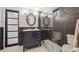 Stylish bathroom with a walk-in shower, vanity, and modern lighting fixtures at 3384 W Arlington Ave, Littleton, CO 80123