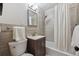 Updated bathroom with a tiled shower and tub, vanity, and modern fixtures at 3384 W Arlington Ave, Littleton, CO 80123
