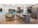 Modern eat-in kitchen with sleek island, stainless steel appliances, and glass door to backyard at 3384 W Arlington Ave, Littleton, CO 80123