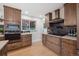 Stylish kitchen featuring custom cabinetry, quartz countertops, and stainless steel appliances at 3384 W Arlington Ave, Littleton, CO 80123
