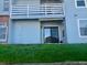 Exterior of home with a sliding door to a back patio and a small patch of lawn at 7665 E Eastman Ave # 110C, Denver, CO 80231