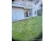 Exterior of home with a sliding door to a back patio and a small patch of lawn at 7665 E Eastman Ave # 110C, Denver, CO 80231