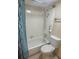 Bathroom with a combined shower and tub, featuring white tiles and modern fixtures at 7665 E Eastman Ave # 110C, Denver, CO 80231