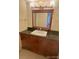 Bathroom vanity with granite countertops, a square sink, and wood cabinets at 7665 E Eastman Ave # 110C, Denver, CO 80231