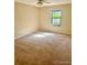 This bedroom features large windows and carpeting at 7665 E Eastman Ave # 110C, Denver, CO 80231