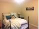 Cozy bedroom featuring a comfortable bed with decorative pillows and a nightstand with a lamp at 7665 E Eastman Ave # 110C, Denver, CO 80231