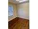 Empty bedroom featuring hardwood floors and a window letting in natural light at 7665 E Eastman Ave # 110C, Denver, CO 80231