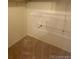 Walk-in closet with neutral carpet and two rows of shelves for efficient storage at 7665 E Eastman Ave # 110C, Denver, CO 80231