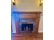Close-up of the fireplace with hardwood mantle and tile surround at 7665 E Eastman Ave # 110C, Denver, CO 80231