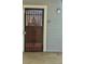 Front door with decorative metal security gate, number 110, and exterior wall lamp at 7665 E Eastman Ave # 110C, Denver, CO 80231