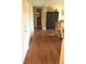 Hallway with hardwood floors, closet doors, and built-in storage at 7665 E Eastman Ave # 110C, Denver, CO 80231