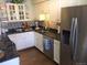 Updated kitchen with white cabinets, granite countertops, and stainless steel appliances at 7665 E Eastman Ave # 110C, Denver, CO 80231
