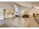 Open-concept living room with sleek tile, modern lighting, and a small kitchen for seamless living and entertaining at 7665 E Eastman Ave # 110C, Denver, CO 80231