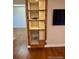 Built-in shelving unit with storage next to the TV mount at 7665 E Eastman Ave # 110C, Denver, CO 80231