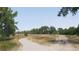 Scenic park view featuring a curved pathway, grassy fields, mature trees, and park benches at 7665 E Eastman Ave # 110C, Denver, CO 80231