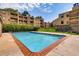Beautiful swimming pool area with multiple residences, great landscaping, and bright blue skies at 7665 E Eastman Ave # 110C, Denver, CO 80231