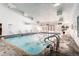 Indoor pool area featuring clean lines, bright lighting, and ample seating for relaxation by the water at 7665 E Eastman Ave # 110C, Denver, CO 80231