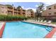 Outdoor swimming pool with plenty of lounge chairs surrounded by well-maintained landscaping and apartment buildings at 7665 E Eastman Ave # 110C, Denver, CO 80231