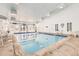 Indoor swimming pool features natural lighting, a shallow end, and a variety of seating options at 7665 E Eastman Ave # 110C, Denver, CO 80231