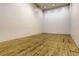 The racquetball court has a hardwood floor with clearly marked lines and bright lighting at 7665 E Eastman Ave # 110C, Denver, CO 80231