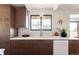 Modern kitchen boasts wood cabinets, marble countertops, and a stylish sink and faucet at 3380 S Oak Ct, Denver, CO 80227