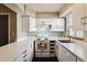 Kitchen showcases white cabinets, countertops, appliances, sink, and a window at 1811 S Quebec Way # 187, Denver, CO 80231