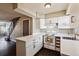 Kitchen features white cabinets, countertops, appliances, sink, and a window at 1811 S Quebec Way # 187, Denver, CO 80231