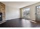 Inviting living room featuring hardwood floors, a cozy stone fireplace, and plenty of natural light at 1811 S Quebec Way # 187, Denver, CO 80231