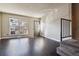 Bright living room with hardwood floors, a large window, and access to the staircase at 1811 S Quebec Way # 187, Denver, CO 80231