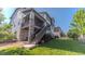 Exterior of home highlighting the backyard, well-manicured lawn, and deck access with stairs at 16383 Ute Peak Way, Broomfield, CO 80023