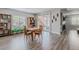 Open basement area with wood-look floors, seating and a sliding glass door at 16383 Ute Peak Way, Broomfield, CO 80023