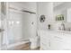 Bright bathroom featuring a glass shower, white vanity with marble countertop, and modern fixtures at 16383 Ute Peak Way, Broomfield, CO 80023